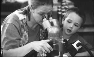 Photo: Woman and child using microscope