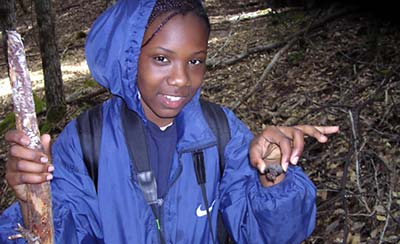  Faith, 13, holds a terrestrial snail she found in the leaf litter during a hike at Angelo Coast Range Reserve.