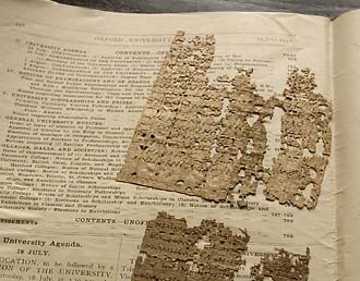 Fragments of papyrus wrapped in pages from the Oxford University Gazette