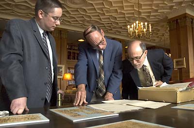 Berkeley scholars examine one of the recently returned papyri