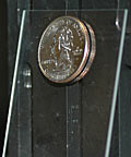 front view of quarter held on inclined glass slide