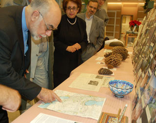  Iranian diplomat looks at map, showing sites of past collaborative botanizing