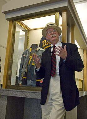 Curator William Benemann describes items in the Plugs to Bling exhibit