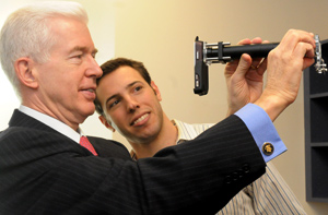 Bioengineering grad student David Breslauer demonstrates the CellScope, a device to aid in the diagnosis of disease in remote areas, to former Governor Gray Davis